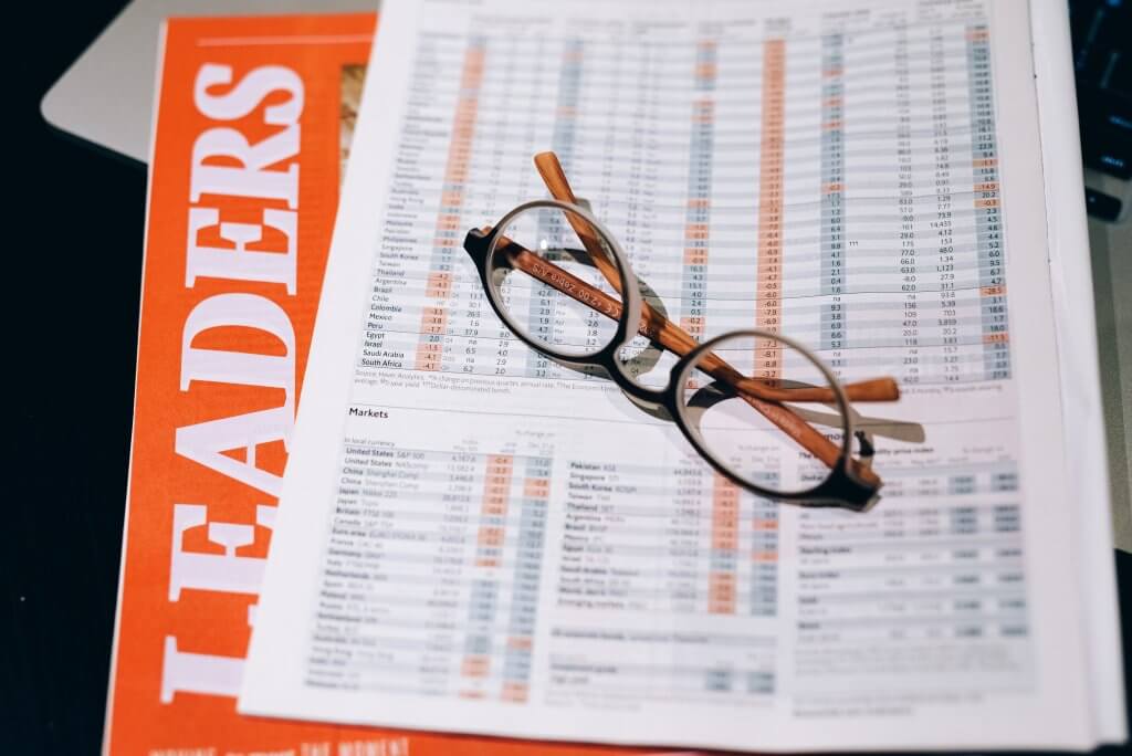 financial reports with specs over them